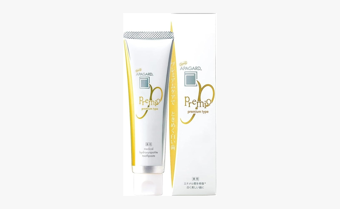 Apagard Premio nano-hydroxyapatite toothpaste tube standing next to its original white and gold retail packaging box.